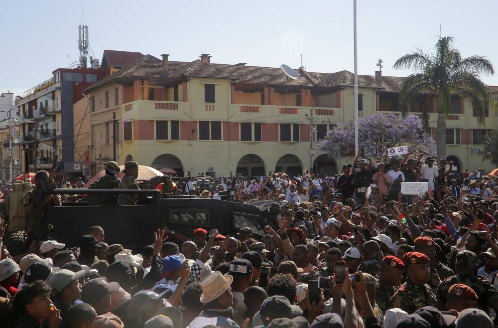 Members of the military leave after joining protesters gathered outside the town hall on Independence Avenue during a nationwide youth-led demonstration against frequent power outages and water shortages, in Antananarivo, Madagascar, on Tuesday. REUTERS