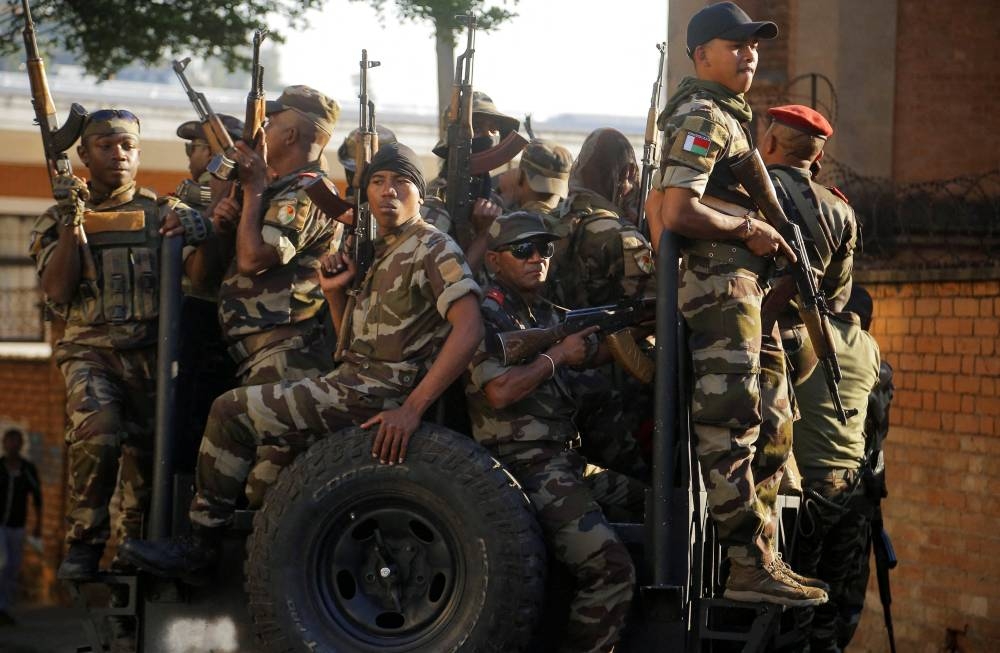 Members of the military operate outside the presidential palace after joining protesters gathered outside the town hall on Independence Avenue during a nationwide youth-led demonstration against frequent power outages and water shortages, in Antananarivo, Madagascar, on Tuesday. REUTERS