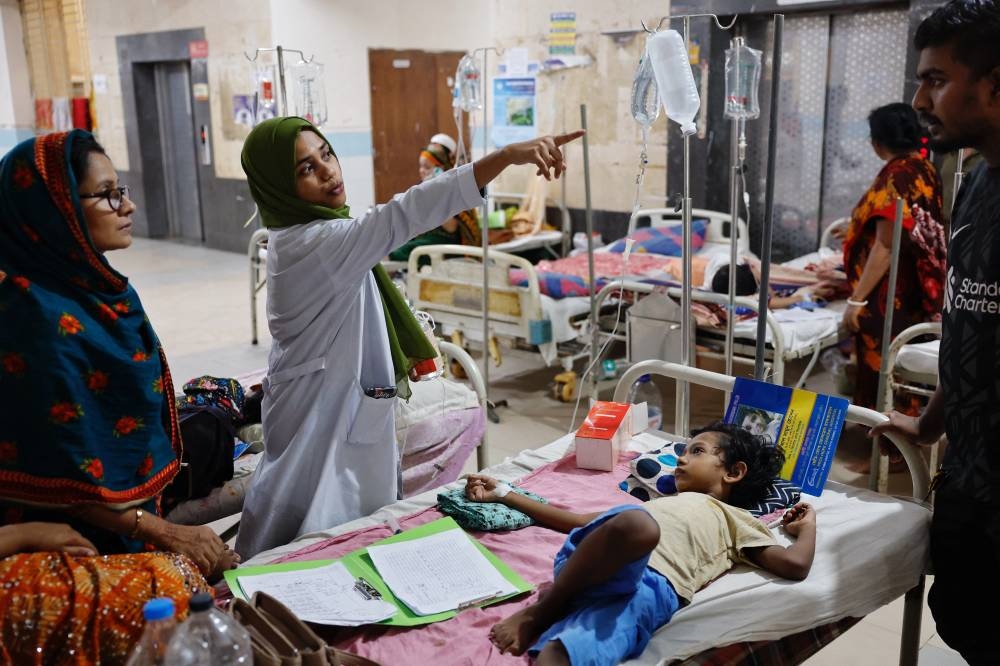 A nurse gives instructions to the family of a dengue infected child who receives treatment at the Mugda Medical College Hospital in Dhaka, on Tuesday. REUTERS