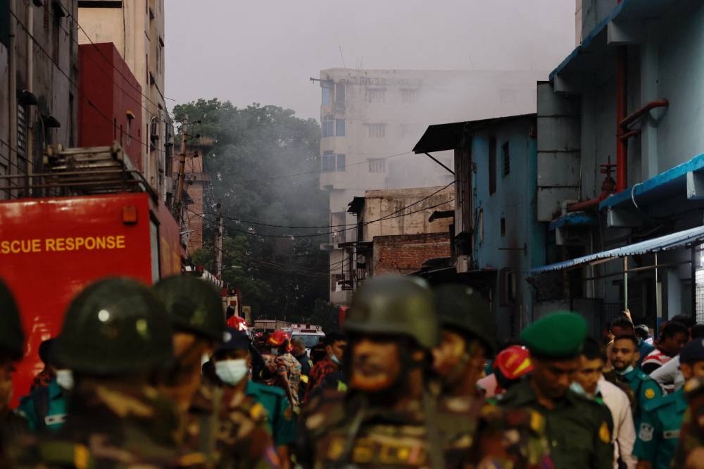 Smoke rises from a building as fire broke out at a garment factory and a chemical warehouse in Dhaka, on Tuesday. REUTERS