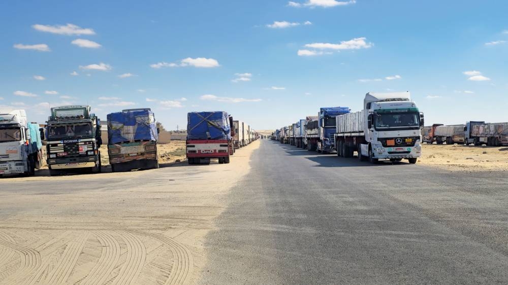 Trucks carrying humanitarian aid prepared by the Egyptian Red Crescent, which are to enter the Rafah crossing into the Gaza Strip Wednesday, line up, after a ceasefire between Israel and Hamas in Gaza went into effect, in Al-Arish, the capital of the North Sinai Governorate, Egypt, on Tuesday. REUTERS