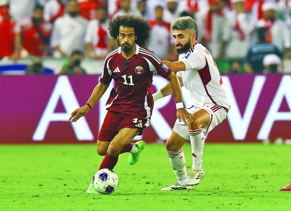Qatar's Akram Afif in action with United Arab Emirates' Yahia Nader. REUTERS