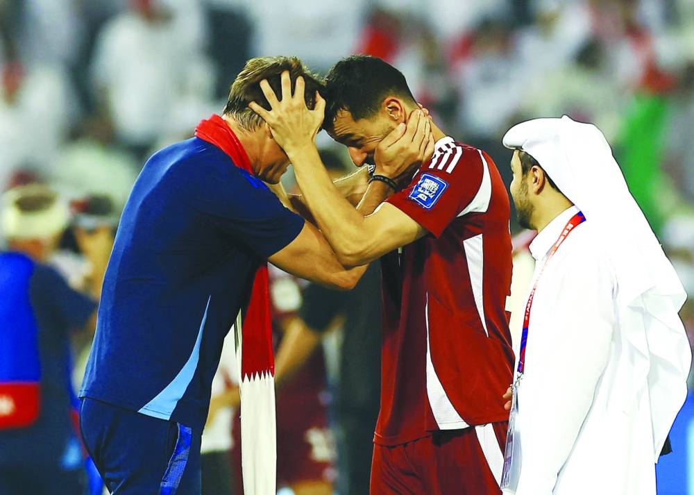 Qatar coach Julen Lopetegui celebrates with Boualem Khoukhi after qualifying for the FIFA World Cup. REUTERS