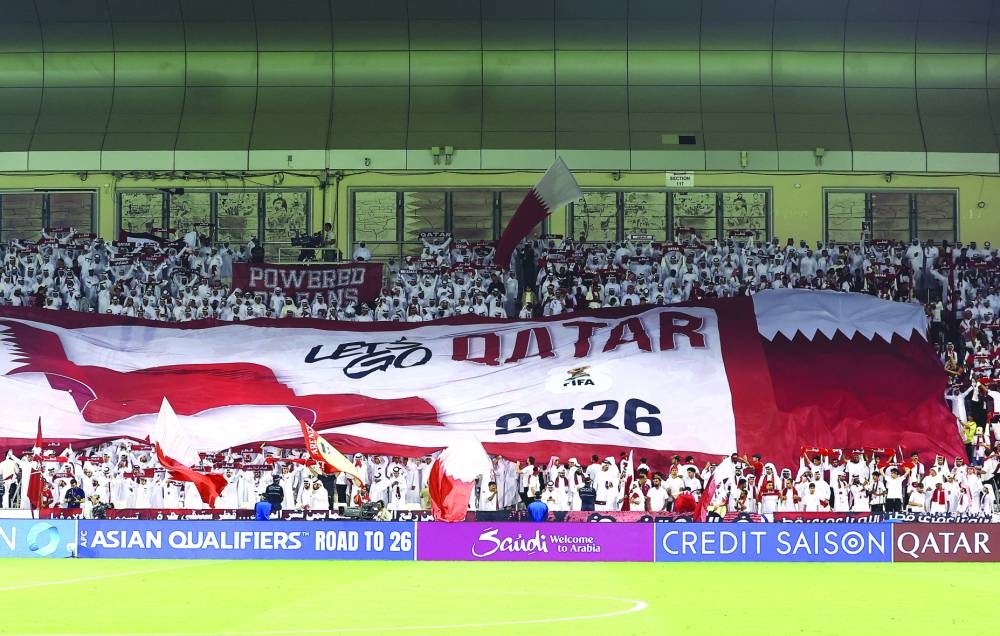 Qatar fans display a banner in the stands before the match. REUTERS