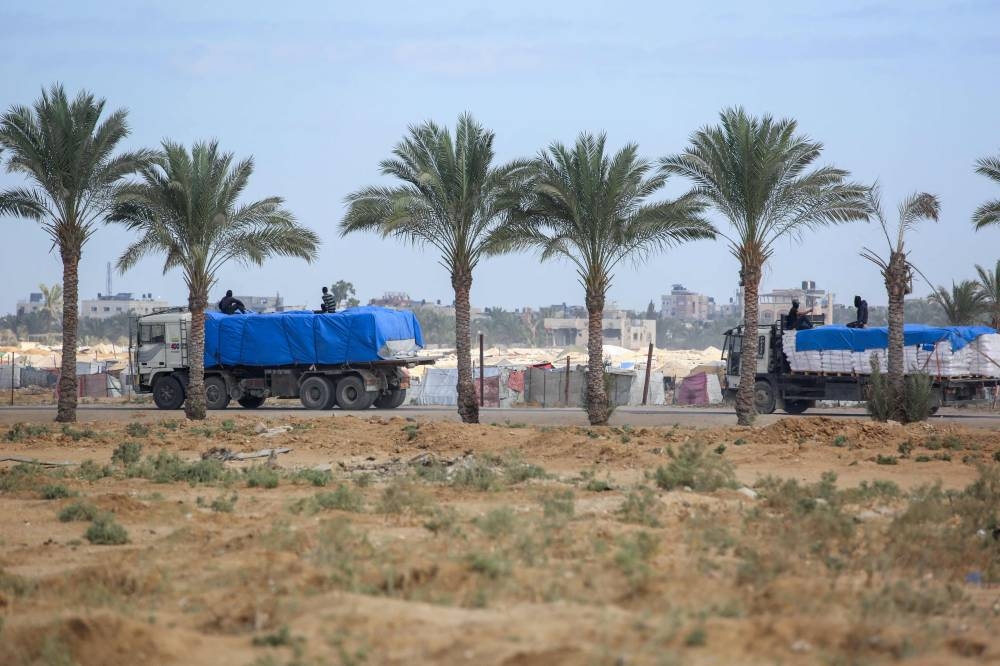 Trucks carrying aid provided by the World Food Programme (WFP) drive on a road in Deir el-Balah in the central Gaza Strip on Wednesday. AFP