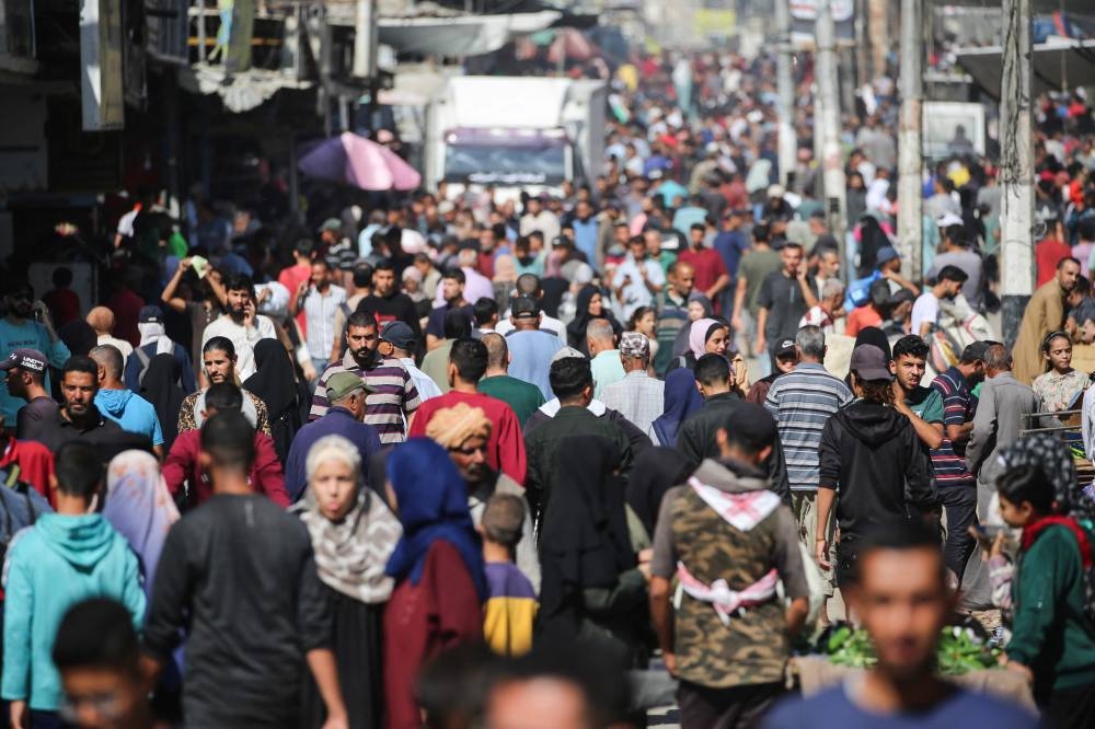 Palestinians shop at a makeshift market in the Nuseirat refugee camp, located in the central Gaza Strip on Wednesday. AFP