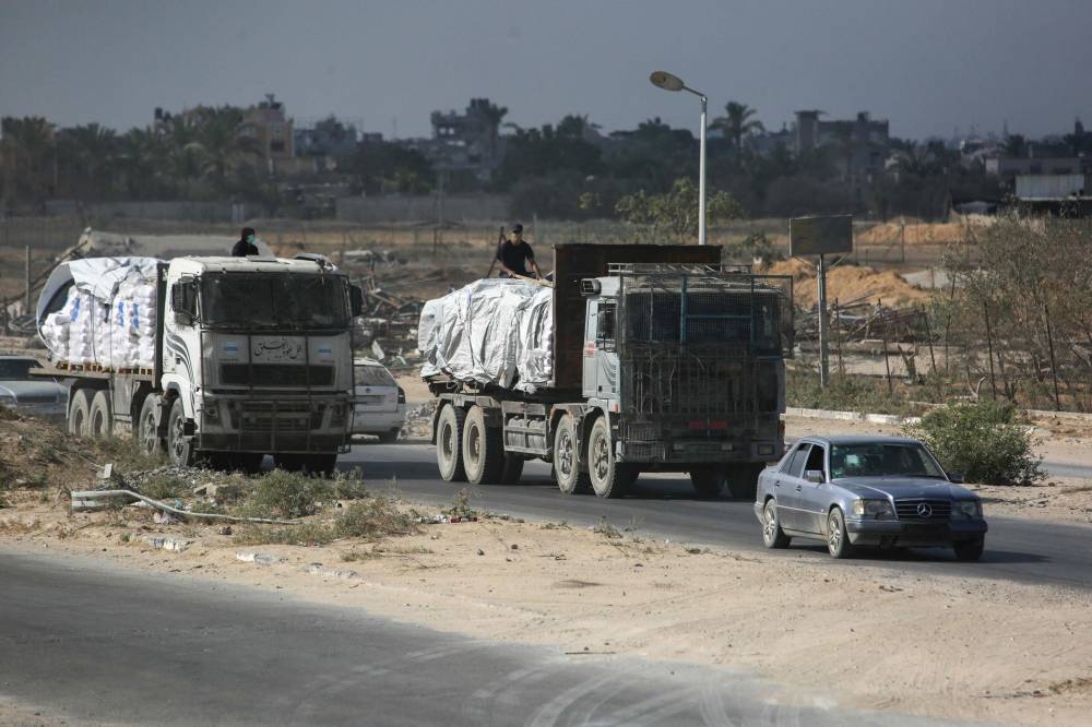 Trucks carrying aid provided by the World Food Programme (WFP) drive on a road in Deir el-Balah in the central Gaza Strip on Wednesday. AFP