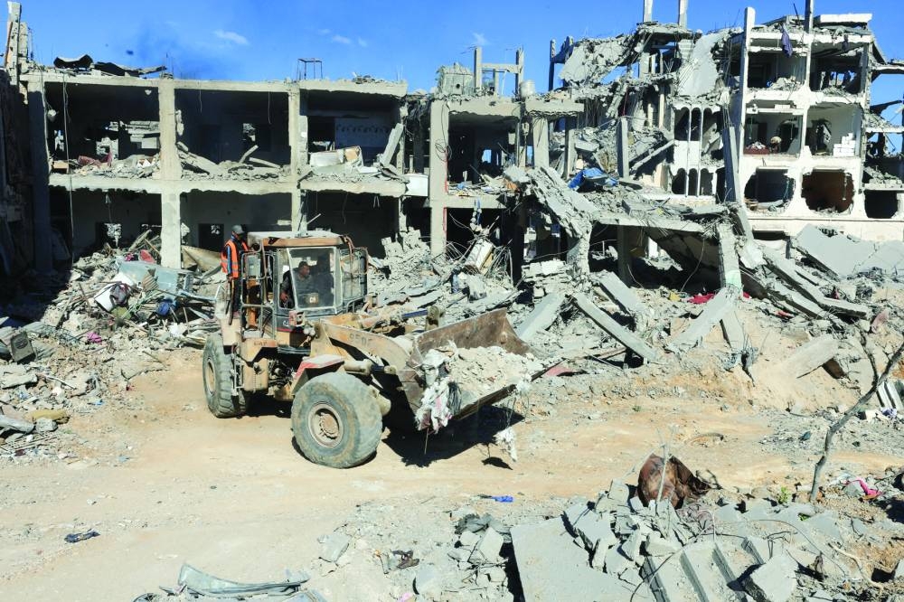 Heavy machinery removes debris from a street, amid a ceasefire between Israel and Hamas, in Gaza City, Tuesday. REUTERS