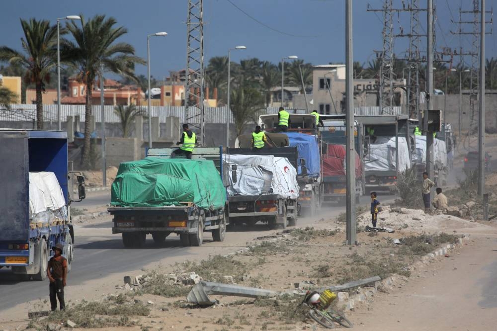 Trucks carrying aid provided by the World Food Programme (WFP) drive on a road in Deir el-Balah after entering through the Kerem Shalom crossing in the southern Gaza Strip, on Friday. AFP