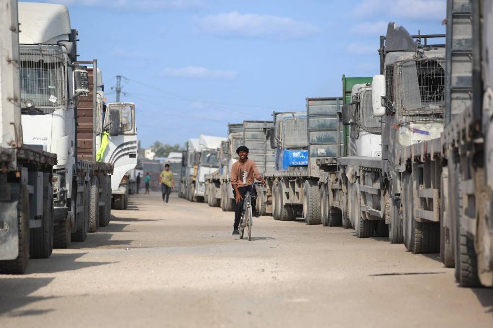 Truck carrying aid provided by the World Food Programme (WFP) wait at the Kissufim crossing, located east of Deir el-Balah in the central Gaza Strip, before entering the Palestinian enclave, on Friday. AFP