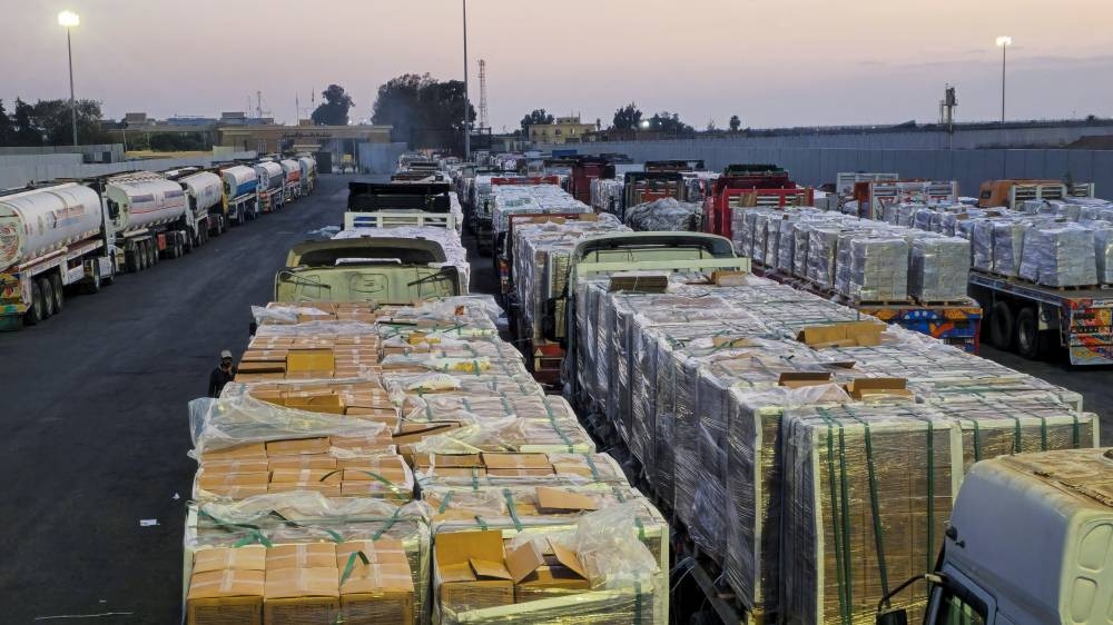 Trucks carrying humanitarian aid and fuel line up at the crossing into the Gaza Strip at the Rafah border on the Egypt side, amid a ceasefire between Israel and Hamas in Gaza, in Rafah, Egypt, on Friday. REUTERS