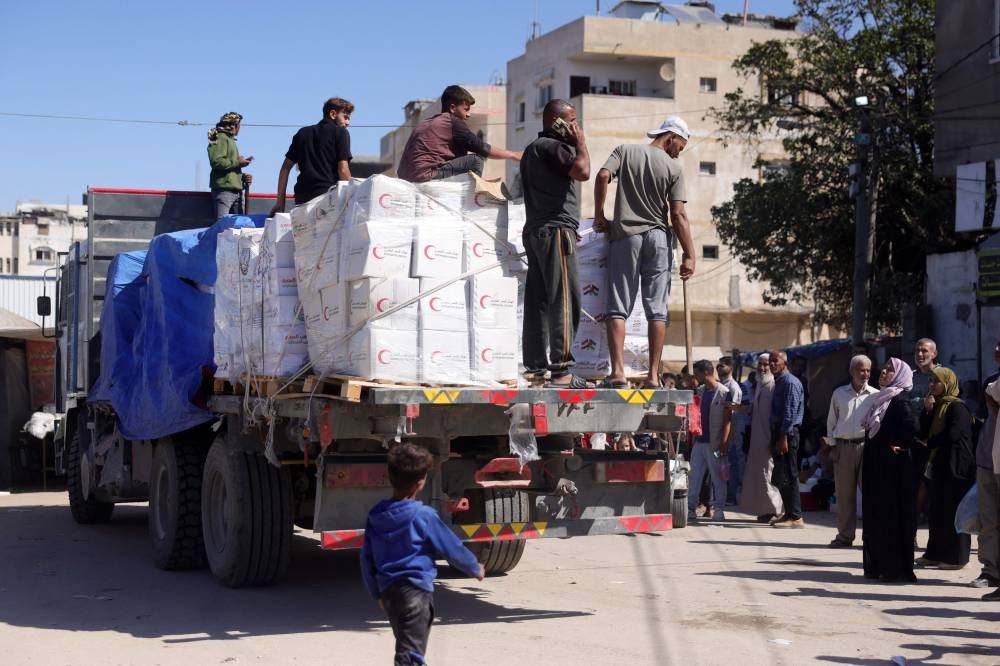 A truck loaded with humanitarian aid enters Deir el-Balah in the central Gaza Strip, more than a week after a ceasefire agreement between Israel and Hamas took hold, on Saturday. AFP