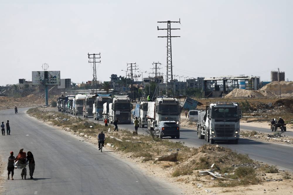 Trucks carry aid for Palestinians, amid a ceasefire between Israel and Hamas in Gaza, in Khan Younis, in the southern Gaza Strip, on Friday. REUTERS