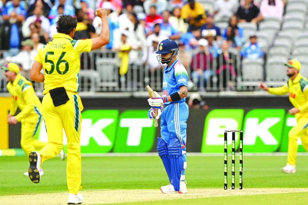 India’s Virat Kohli (centre) reacts as Australia’s paceman Mitchell Starc (left) celebrates his wicket during the first ODI in Perth Sunday. AFP