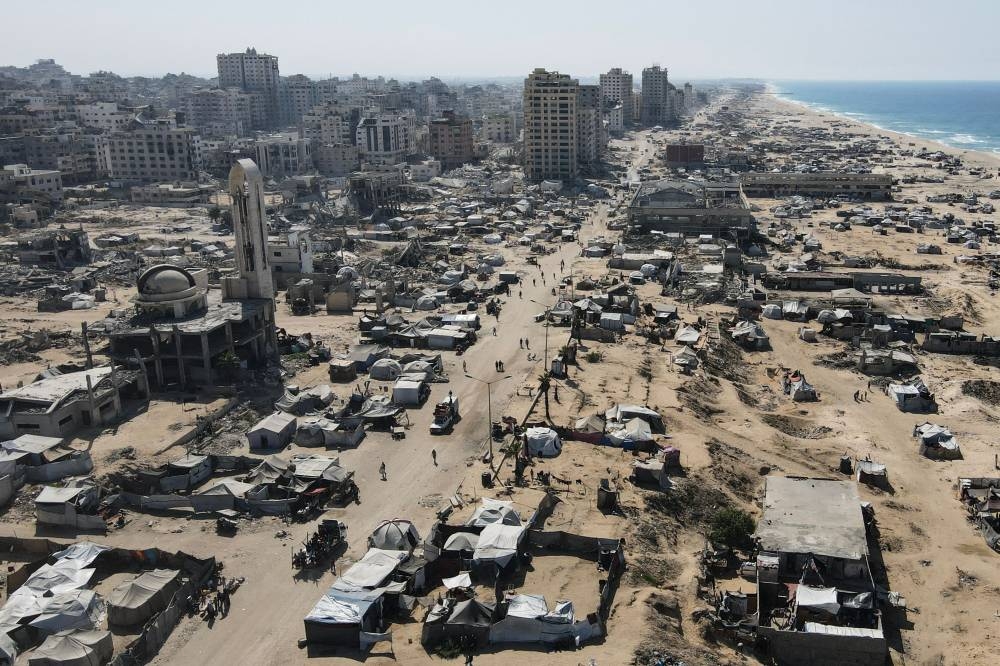 An aerial view shows tents sheltering displaced Palestinians in the war-damaged area surrounding Gaza City's port on Monday, during a US-brokered ceasefire between Israel and Palestinian factions. AFP