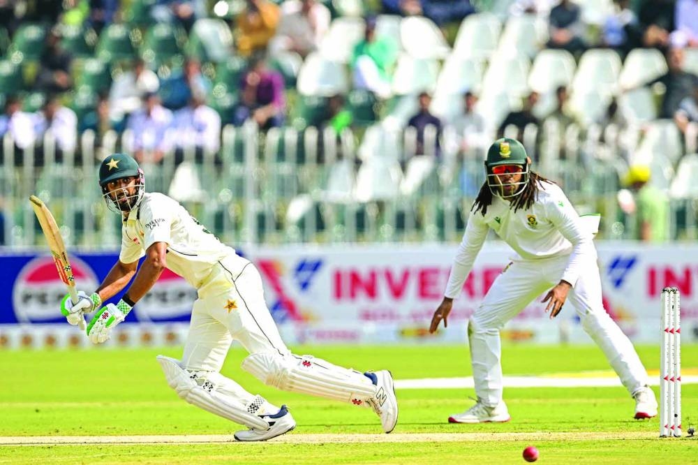 Pakistan's captain Shan Masood (left) watches the ball after playing a shot as South Africa's Tony de Zorzi reacts during the first day of the second Test at the Rawalpindi Cricket Stadium in Rawalpindi on Monday. AFP