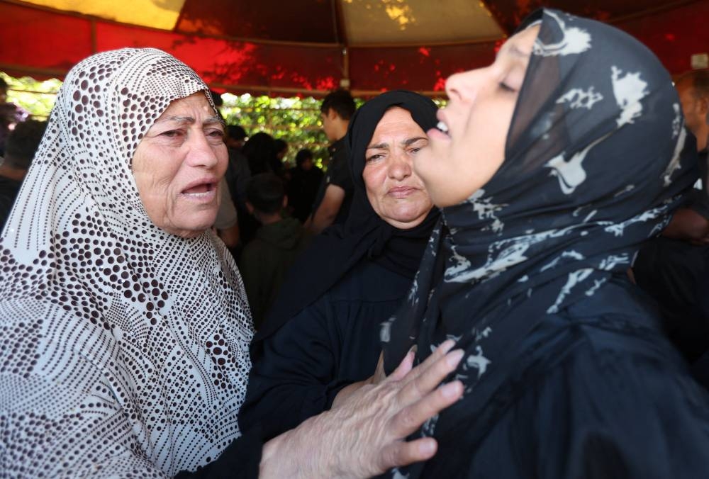 Mourners react during the funeral of Palestinians killed in Israeli strikes on Sunday, according to medics, at Nasser Hospital in Khan Younis, southern Gaza Strip, on Monday. REUTERS