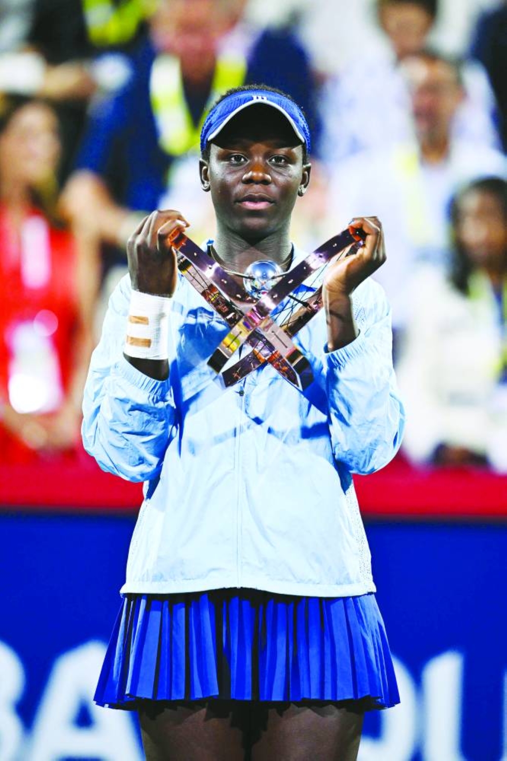 Victoria Mboko of Canada celebrates as she holds up the trophy following her victory against Naomi Osaka of Japan in Canadian Open in Montreal. AFP