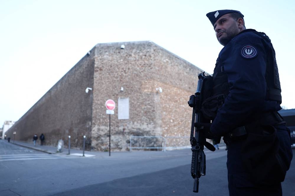 French police secure the area near the Prison de la Sante (Centre penitentiaire de Paris La Sante) before the arrival of former French President Nicolas Sarkozy to begin his five-year prison sentence, in Paris on Tuesday.  REUTERS
