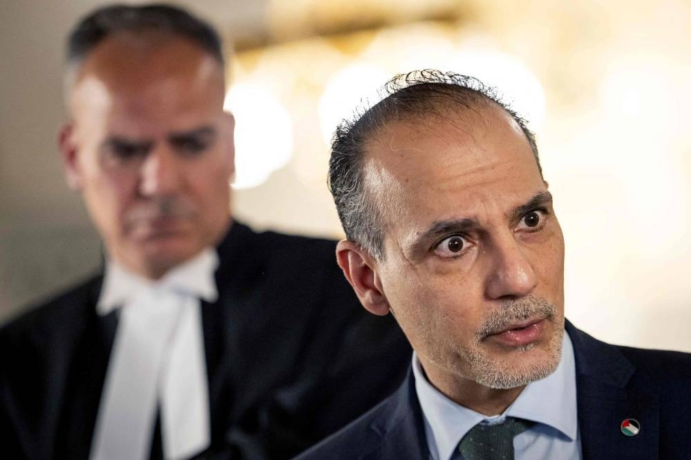 Ambassador and Permanent Representative of the Palestinian Authority to International Organizations in the Netherlands Ammar Hijazi (R) attends a press conference following the hearing of the International Court of Justice (ICJ) in The Hague on Wednesday, to issue an advisory opinion on Israel's obligations to provide assistance in the occupied Palestinian territories. AFP
