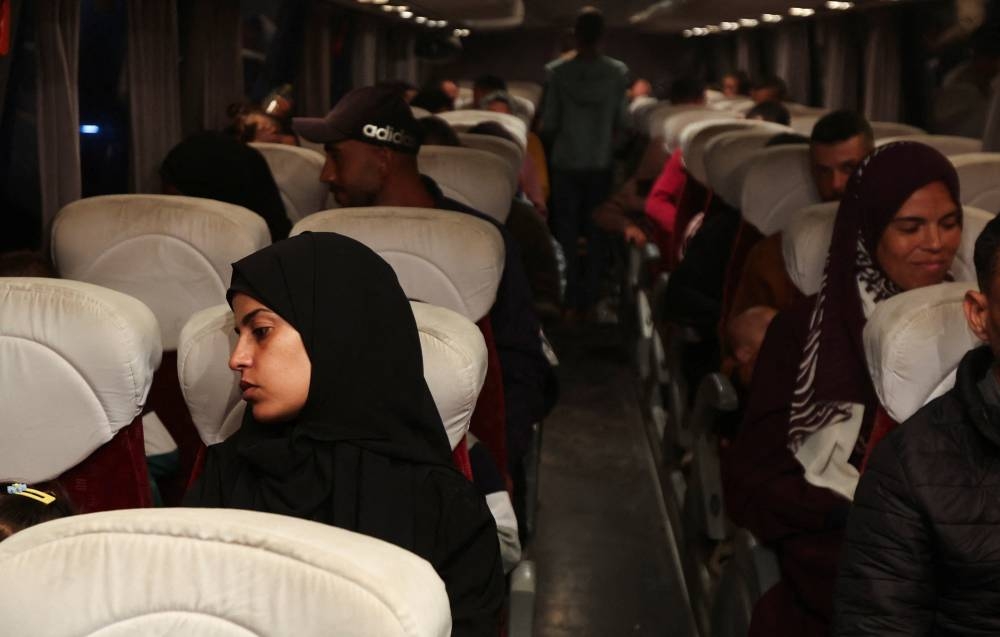 Palestinian patients ride in a bus before they are transferred for medical treatment abroad, amid a ceasefire between Israel and Hamas in Gaza, in Khan Younis, in the southern Gaza Strip, on Wednesday. REUTERS