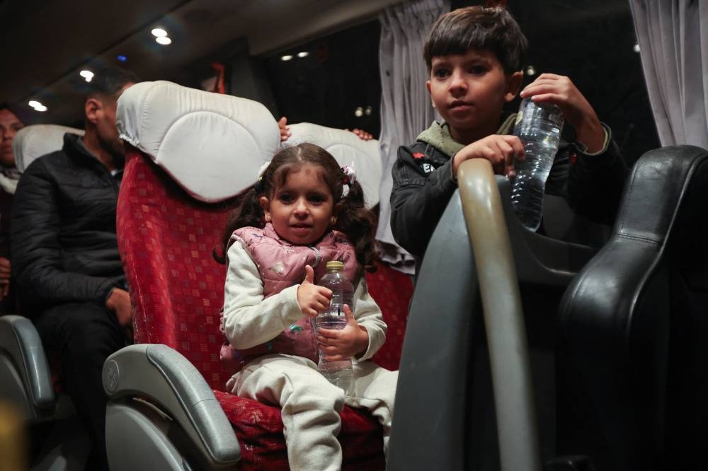 Palestinian patients ride in a bus before they are transferred for medical treatment abroad, amid a ceasefire between Israel and Hamas in Gaza, in Khan Younis, in the southern Gaza Strip, on Wednesday. REUTERS