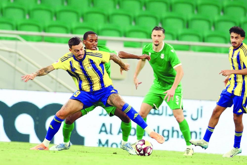 Al Gharafa’s Joselu vies for the ball with Al Ahli players at the Al Thumama Stadium.