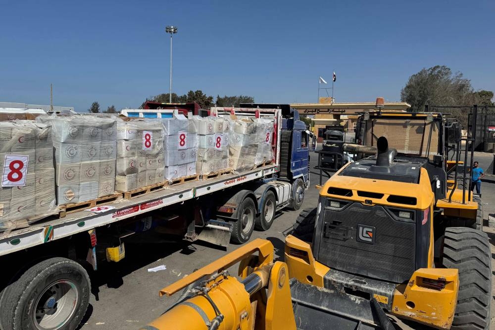 Trucks and Egyptian heavy machinery wait on the Egyptian side of the Rafah border crossing with the Gaza Strip on Sunday. AFP
