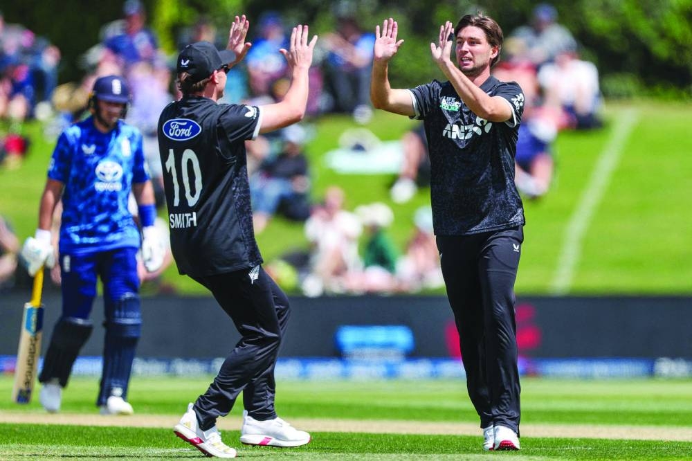 New Zealand’s Zakary Foulkes (right) celebrates a wicket with Nathan Smith during the first one-day international against England at Bay Oval in Tauranga Sunday. AFP