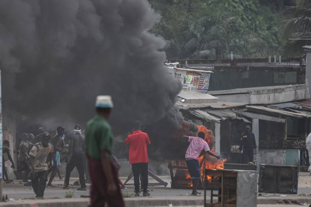 Supporters of the Cameroon opposition candidate Issa Tchiroma clash with security forces during a protest after the Constitutional Council declared President Paul Biya as the winner of the October 12 presidential election, in Douala, Cameroon, on Monday. REUTERS