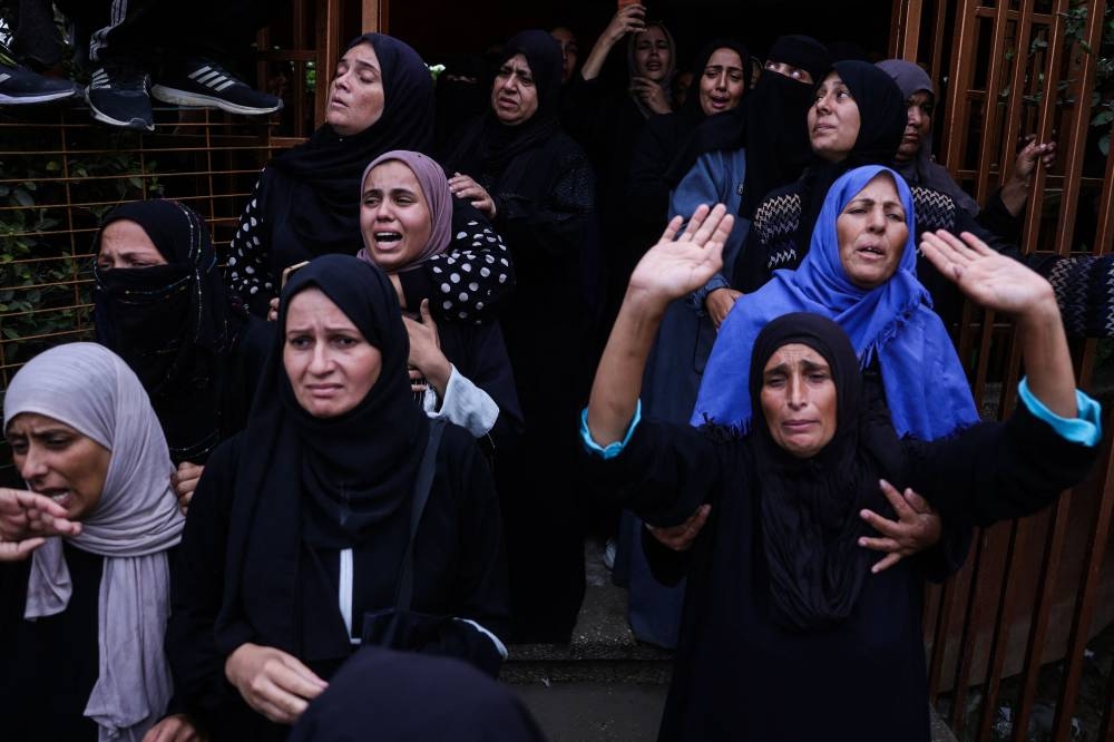 Relatives mourn during the funeral of Palestinians killed in an Israeli strike, at Nasser Hospital in Khan Yunis in the southern Gaza Strip, on Wednesday. AFP