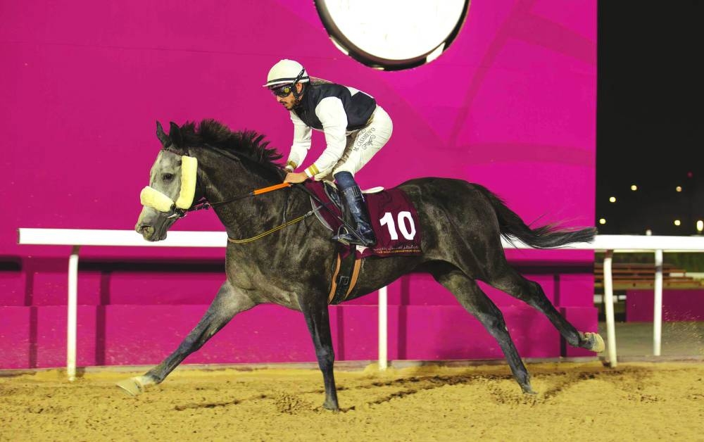 Mohtaram made a sparkling Qatar debut, breaking his maiden impressively with a commanding performance in the Al Beshariyah Cup, a Purebred Arabian Premium Maiden Plate for four–seven-year-olds over 1900m, yesterday. The four-year-old grey colt came from behind with an eye-catching turn of foot in the home straight to score by 4½ lengths for Al Ghazali Stud and trainer Mohammed al-Ghazali, completing a double on the day for jockey Marco Casamento. Rashid Saed Adiba, Head of QREC Racing Operations Section, crowned the winners. PICTURES: Juhaim
