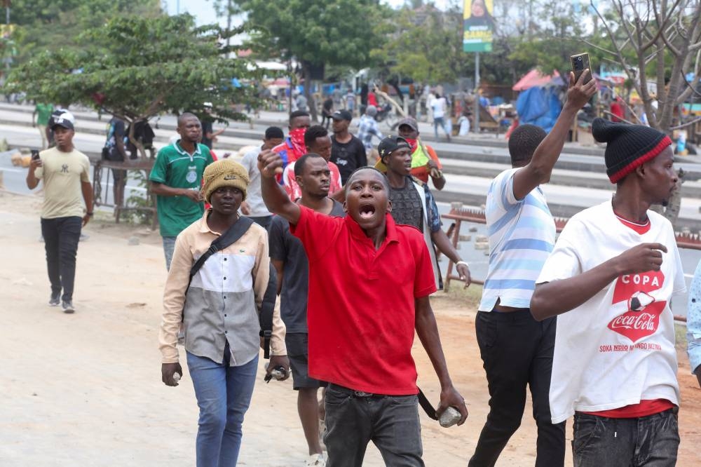 Demonstrators participate in violent protests that marred the election following the disqualification of the two leading opposition candidates in Dar es Salaam, Tanzania, on Wednesday. REUTERS
