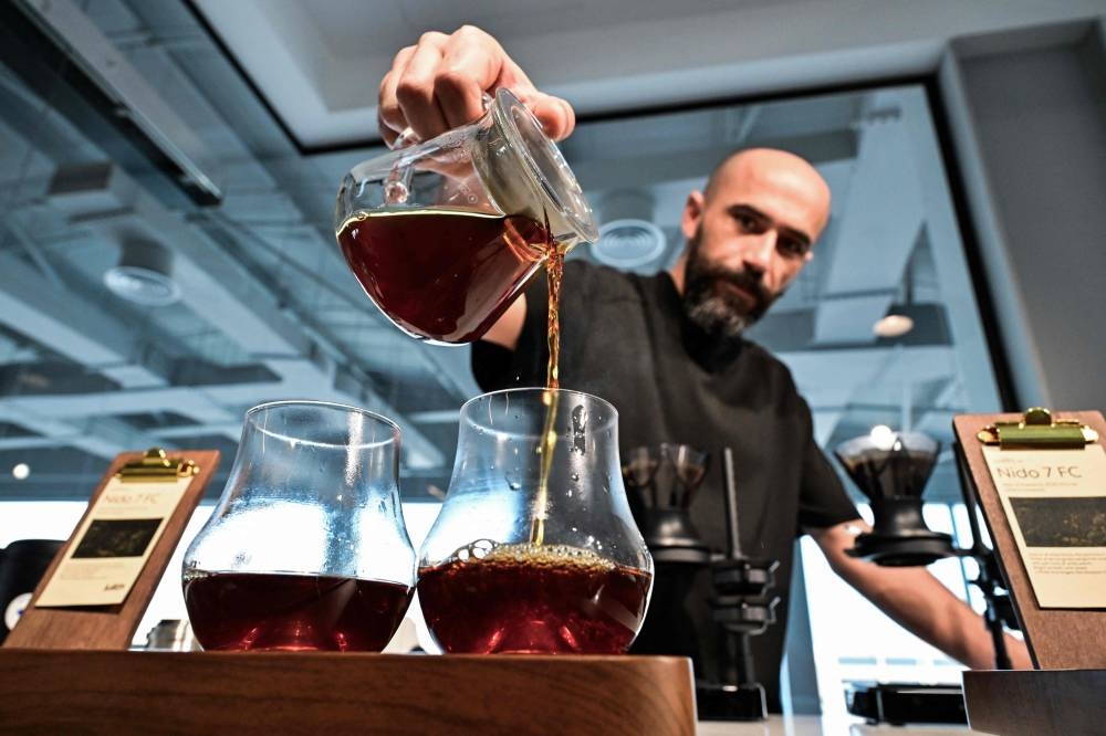 Barista Serkan Sagsoz, co-founder of Julith Coffee, prepares Nido 7FC Panama coffee that costs 3600 AED (around 980 US dollars) at his cafe in Dubai on Thursday. AFP