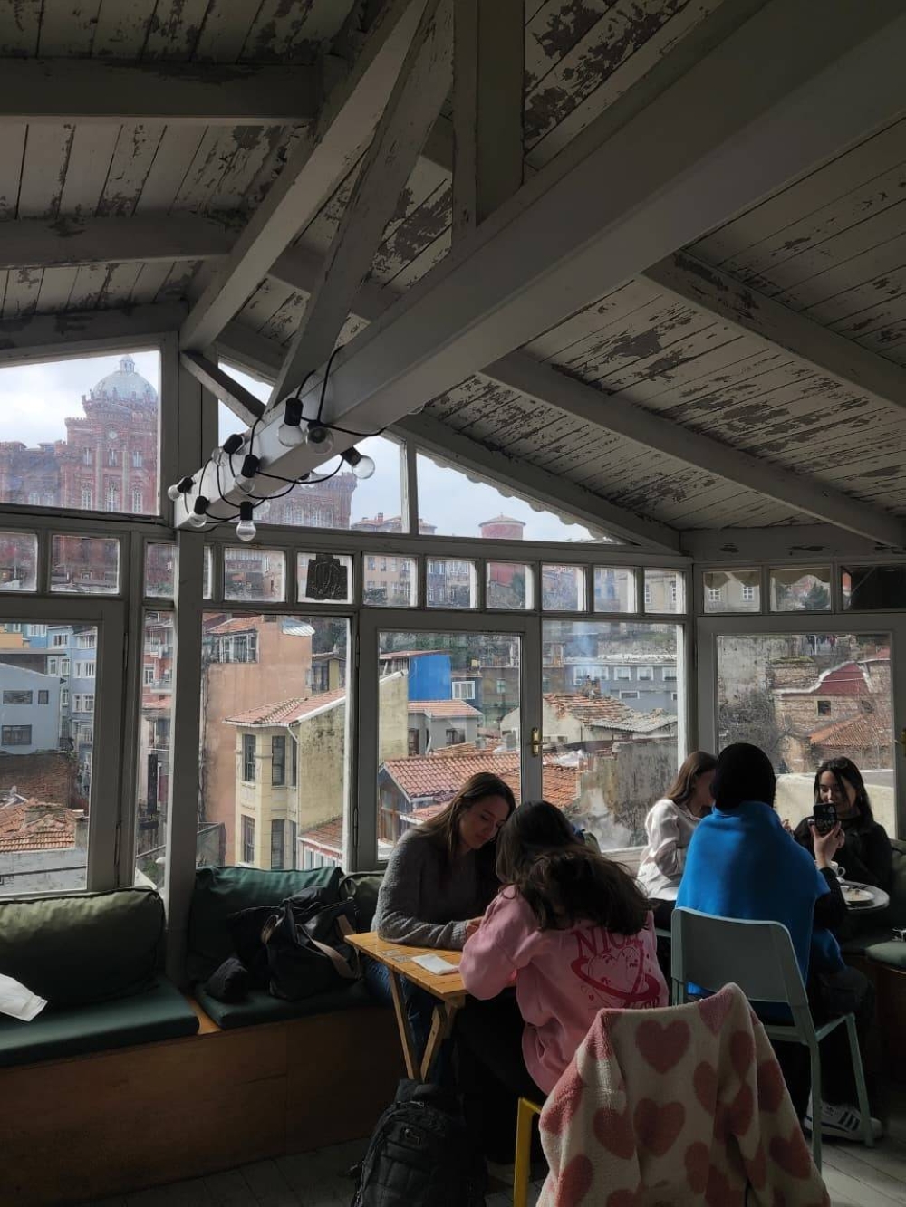 -A rooftop café in Balat, offering views of Istanbul’s colorful homes and streets.