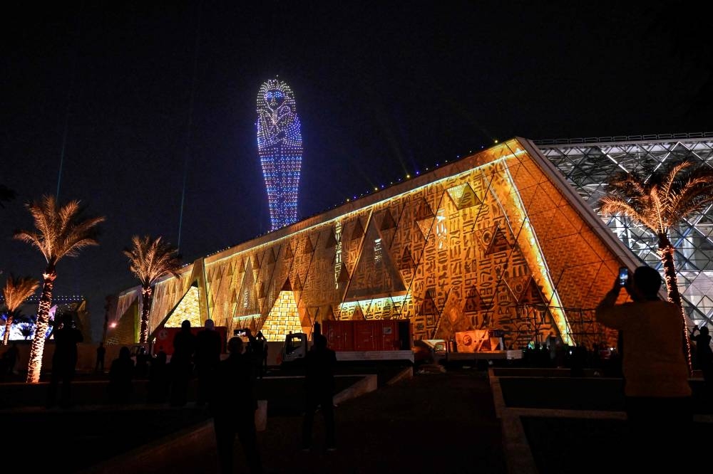 Lightning effects depicting the sarcophagus Egyptian King Tutankhamun light up the sky during the opening ceremony of the Grand Egyptian Museum (GEM) in Giza, on the southwestern outskirts of the capital Cairo on Saturday. AFP