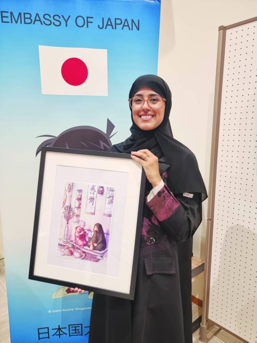 Emerging Qatari artist Moza al-Marri showing her artwork, titled “Qahwa to Ocha - Coffee and Tea,” during the awards ceremony at the Embassy of Japan recently. PICTURE: Joey Aguilar