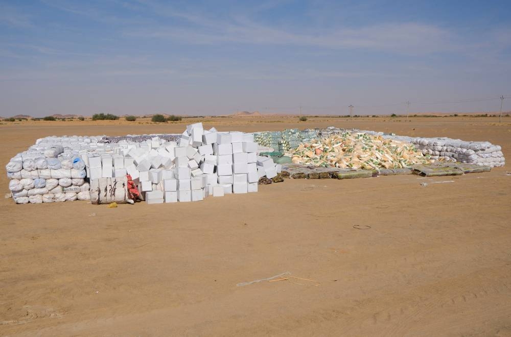 Food aid for internally displaced people from El-Fasher, provided by Qatar Charity, sit in a camp in Al-Dabbah, Sudan, on Monday. REUTERS