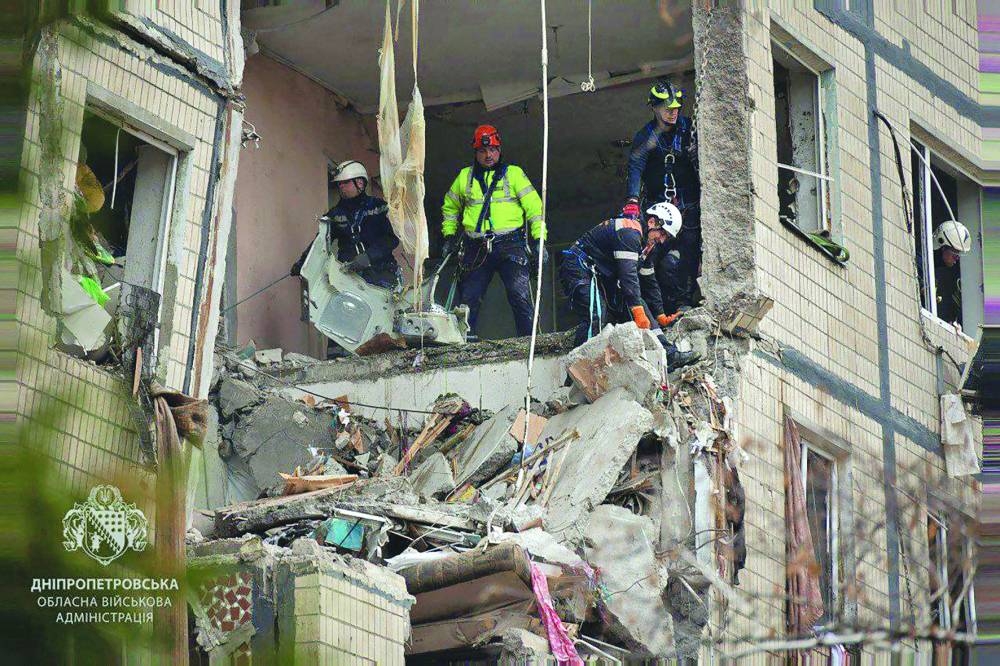 
Ukrainian rescuers work at the site of a heavily damaged residential building following an air attack in Dnipro. (AFP) 