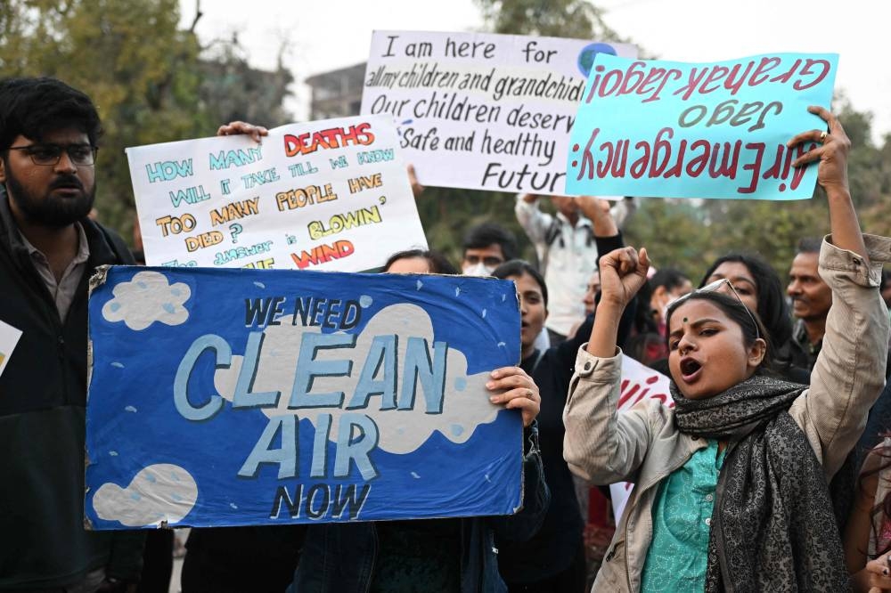 Demonstrators hold posters during a protest demanding the government take action to reduce air pollution in New Delhi on November 9, 2025. (AFP)