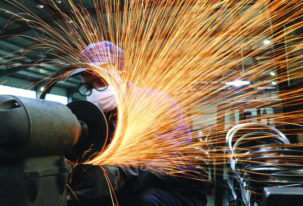 A employee works at a production line at a factory in Hangzhou, Zhejiang province, China (file). The producer price index fell 2.1% in October from a year earlier, National Bureau of Statistics data showed, compared with an expected 2.2% decline in a Reuters poll of economists. The index has remained negative since October 2022 and dropped 2.3% in September.