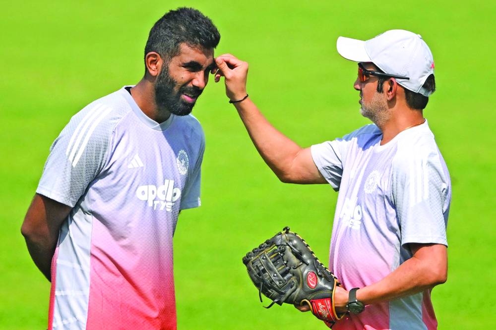 Indian coach Gautam Gambhir (R) and Jasprit Bumrah interact during a practice session ahead of their first Test cricket match against South Africa, at the Eden Gardens in Kolkata on November 11, 2025. (AFP)