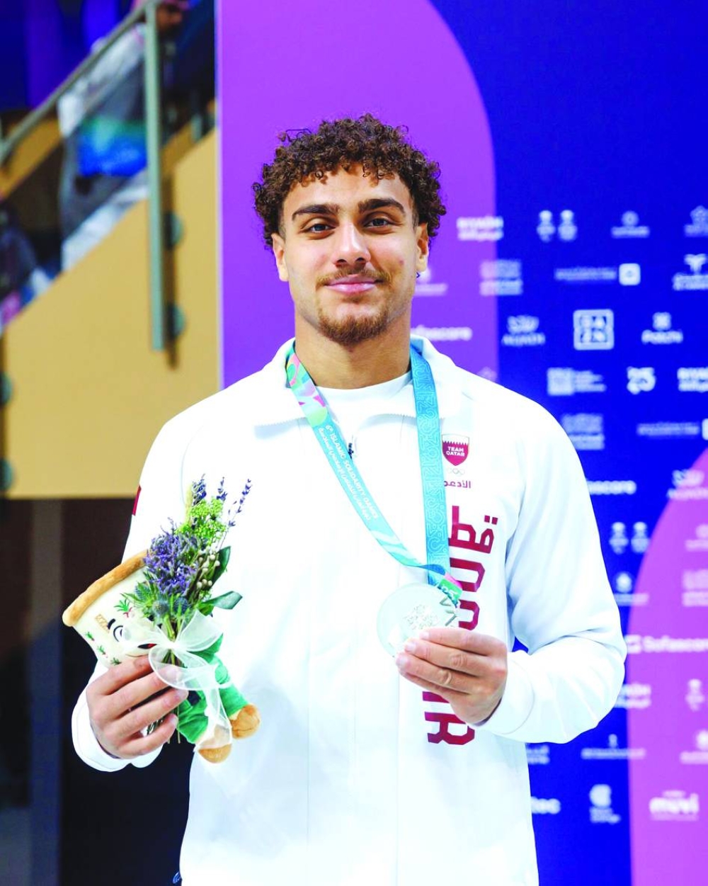 Qatar's Ali Tamer poses with his silver medal at the Islamic Solidarity Games in Riyadh.