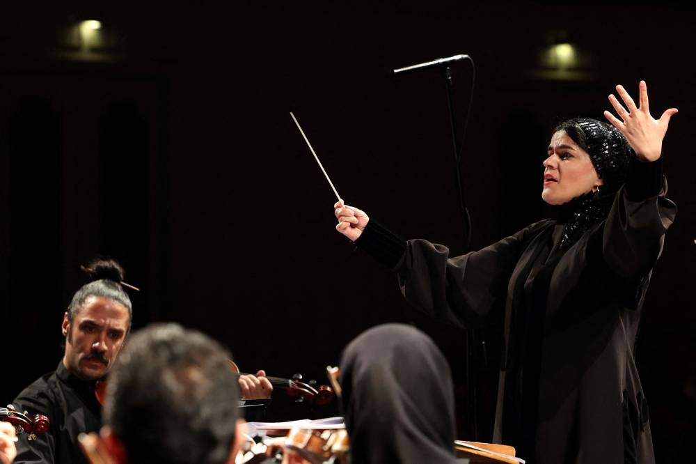Paniz Faryoussefi, the first female conductor, leads the Iranian symphony orchestra at the Vahdat hall in Tehran.