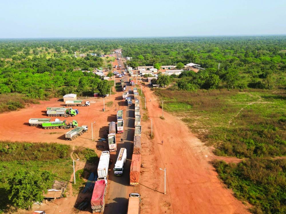 This aerial view shows Malian trucks waiting to cross the border between Ivory Coast and Mali in the village of Nigoun, near Tengrela on October 31, 2025. 