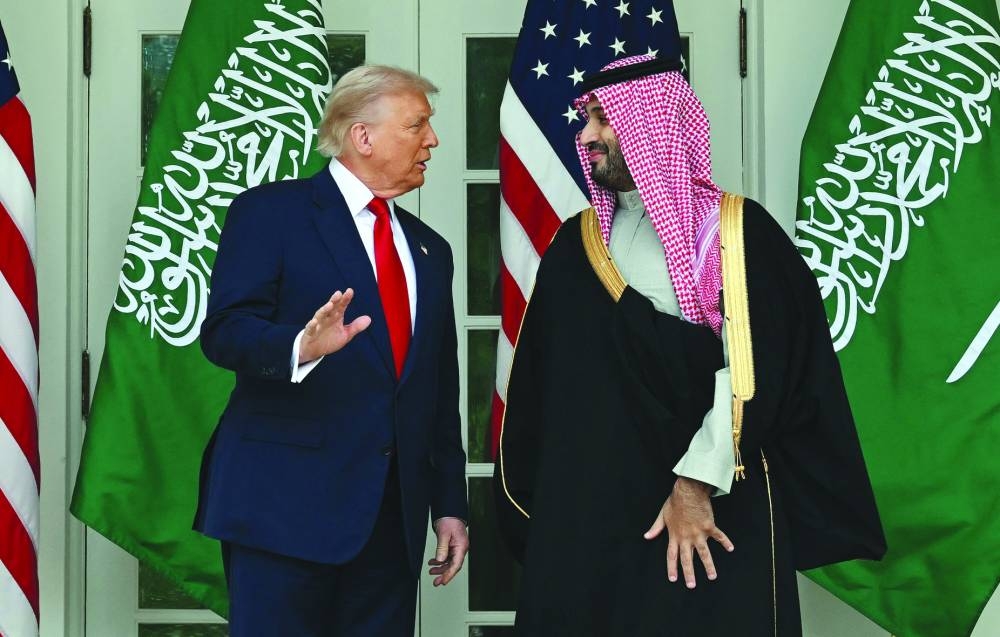 US President Donald Trump (L) and Crown Prince and Prime Minister of the Kingdom of Saudi Arabia Mohammed bin Salman pose for a photo on the Colonnade of the White House in Washington, DC on November 18, 2025. Saudi Crown Prince Mohammed bin Salman arrived at the White House to fanfare and a jet flyover Tuesday, in his first visit to the United States since the 2018 murder of journalist Jamal Khashoggi. (Photo by ANDREW CABALLERO-REYNOLDS / AFP)