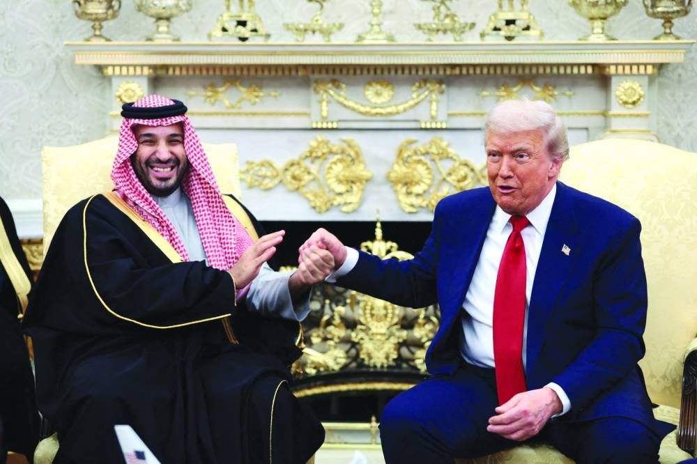 U.S. President Donald Trump and Saudi Crown Prince and Prime Minister Mohammed bin Salman hold hands during a meeting in the Oval Office at the White House in Washington, D.C., U.S., November 18, 2025.  REUTERS/Evelyn Hockstein