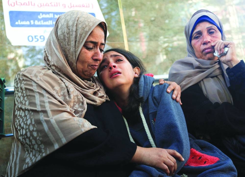 Mourners react as they attend the funeral of Palestinians who  were killed in overnight Israeli strikes, at Al-Shifa Hospital in Gaza City, Thursday.