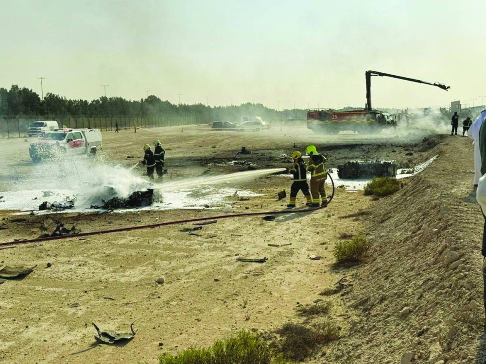 Firefighters work at the site of a crash involving an Indian-made HAL Tejas fighter jet at the Dubai Air Show, UAE, yesterday. 