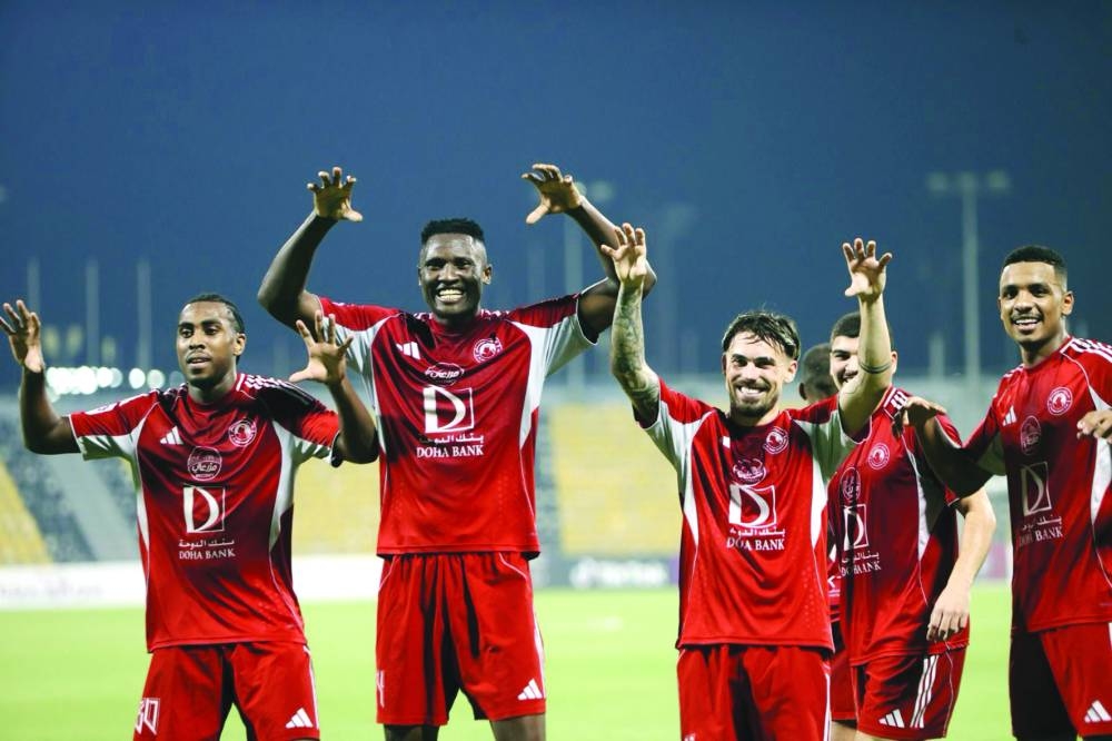 Al Arabi players celebrate their 5-1 win over Qatar SC Sunday.